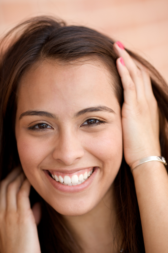 Woman smiling after healing from tooth extractions at Greashaber Dentistry in Ann ArborMI.