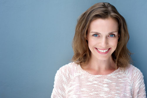 A woman smiling after a broken tooth repair at Greashaber Dentistry in Ann Arbor, MI