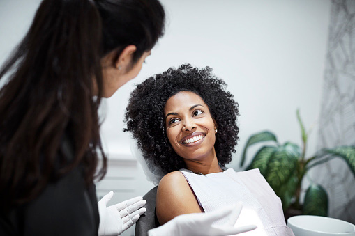 Image of a smiling woman after finding out her dental care is affordable at Greashaber Dentistry in Ann Arbor, MI.