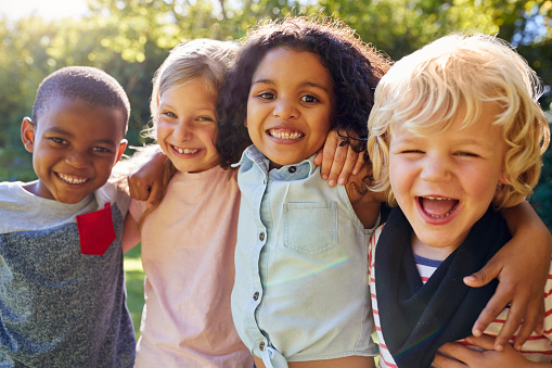 A group of young kids smiling at Greashaber Dentistry in Ann Arbor, MI