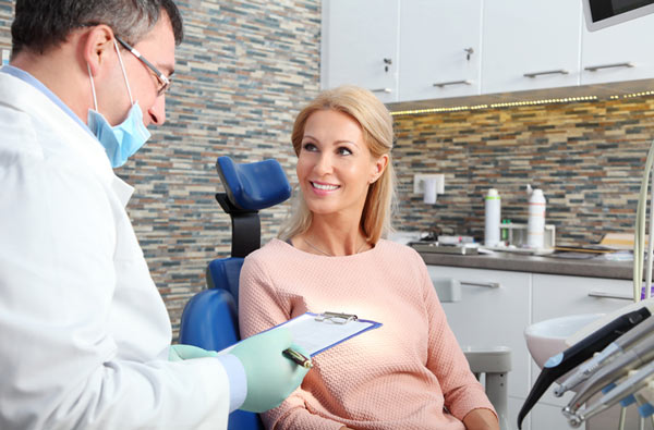 Woman talking to dentist at Greashaber Dentistry in Ann Arbor, MI 48104-3811
